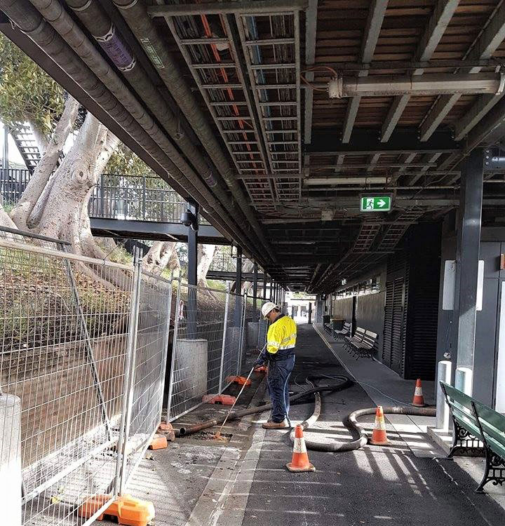 Hydro excavation being carried out at Adelaide Oval by a member of the South Vac crew.