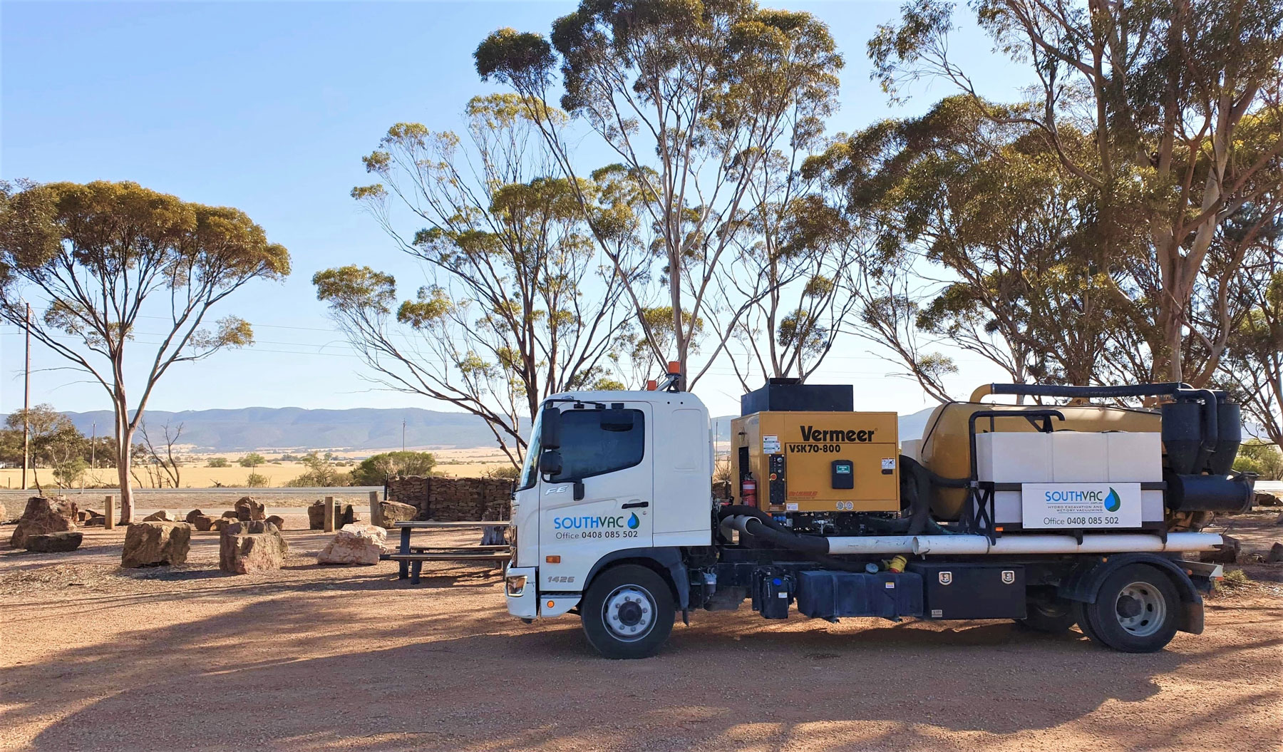 Hydro excavation truck called South Vac 2 parked in front of a view of the Flinders Ranges